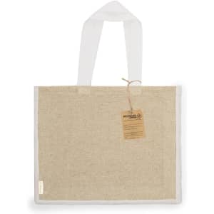A beige tote bag with white handles, featuring a tag and a simple logo. Made from recycled materials.