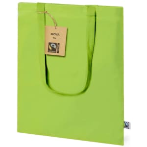 A green tote bag with handles, featuring a tag and a logo. A simple and eco-friendly design.
