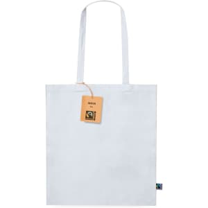 A white tote bag with long handles, featuring a tag and a logo. The bag is made from Fairtrade materials.
