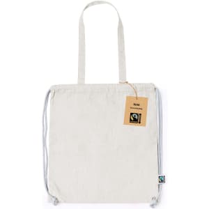 A Fairtrade drawstring bag in a light grey colour with a logo and a tag attached.