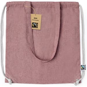 A pink Fairtrade drawstring bag with a drawstring closure and a label, featuring a logo.
