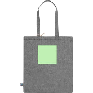 A grey tote bag featuring a square green patch and two handles. The bag has a logo on one side.