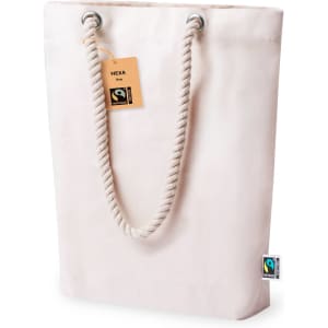 A pale pink tote bag with a rope handle and a tag, featuring a branding logo.