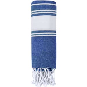 A blue and white striped towel pareo with fringed edges, featuring a sleek and lightweight design.