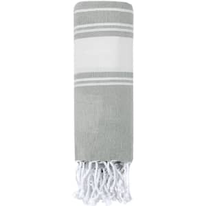 A grey and white striped towel pareo with tasselled edges. It features a simple, elegant design.