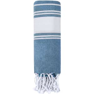 A blue and white striped towel with tassels at the end, featuring a simple, elegant design.