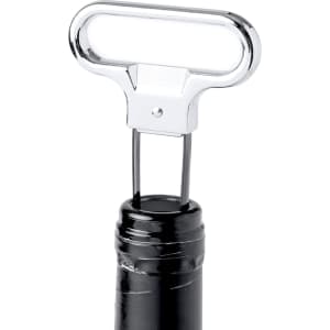 A chrome corkscrew with a T-shaped handle positioned on a wine bottle neck. Features a logo on the handle.