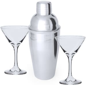 A silver cocktail shaker with two clear martini glasses on either side. Suitable for home mixology.
