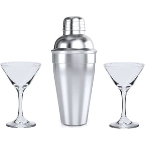 A stainless steel cocktail shaker with two clear glass martini glasses on either side.