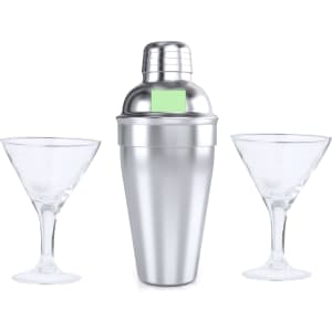 A silver cocktail shaker with two clear martini glasses beside it, all on a white background.