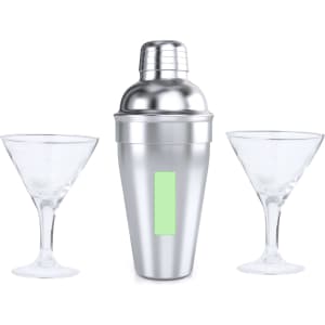 A silver cocktail shaker with two clear martini glasses. The shaker has a logo.