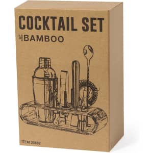 A bamboo cocktail set in a cardboard box, featuring a shaker, stirring spoon, and various bar tools.