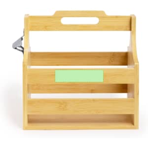 A drink bottle holder made of bamboo with a handle and a minimalist design, featuring a light green label area.