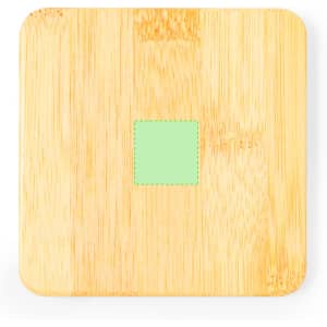 A bamboo coaster in a square shape, featuring a small green square in the centre. It has a smooth, natural finish.