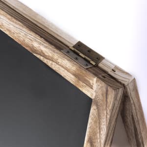 A rustic wooden whiteboard with a metal hinge, featuring a dark writing surface and natural wood tones.