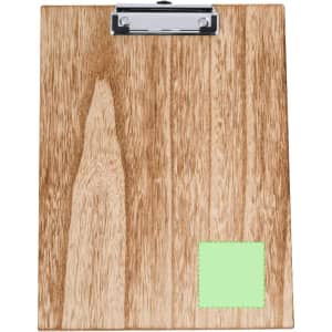 A wooden clipboard with a silver clip and a green sticky note on the bottom right corner.