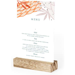 A wooden menu holder displaying a colourful floral design, with a menu listing options for salad, soup, and dessert.