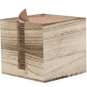 A wooden napkin holder featuring a natural finish with a textured surface and a stack of paper napkins inside.