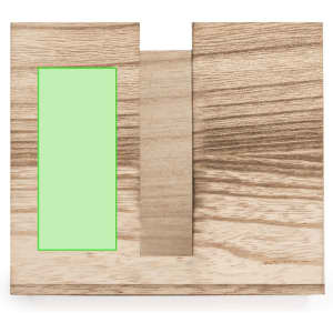 A wooden napkin holder with a natural finish, featuring a rectangular slot and a simple design.