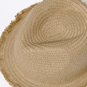 A straw hat in a natural beige hue with a frayed edge detail. Features a simple design and includes a branding logo.