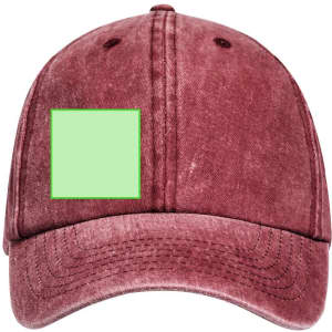 A burgundy cap featuring a blank green patch, designed for customisation. The cap has a classic, casual style.