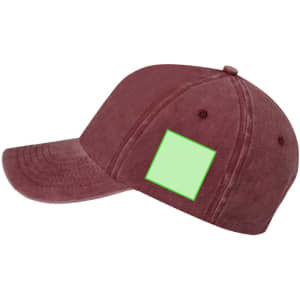 A maroon cap with a curved brim and a blank rectangular area on the side for customisation.