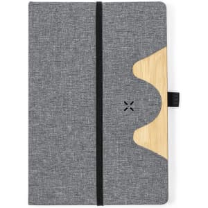 A grey notepad with a wooden accent and an elastic band closure. It features a logo on the front.