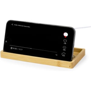 A bamboo wireless charger with a slot for a smartphone, featuring sleek design and natural colour.