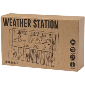 A weather station in a brown cardboard box features digital displays for time, humidity, and temperature, with a wood-effect design.