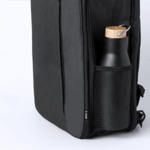 A black backpack with a mesh side pocket containing a black drink bottle with a wooden lid.
