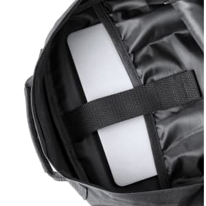 A black backpack interior featuring a padded compartment for a laptop and storage straps. It has a logo visible.