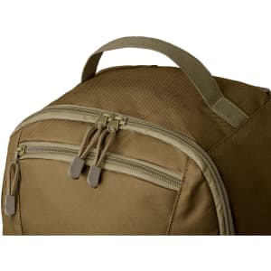 A tan backpack featuring a top handle and zippered compartments. It has one visible logo on the fabric.
