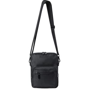 A black shoulder bag with a long adjustable strap, featuring multiple zipped pockets and a logo.