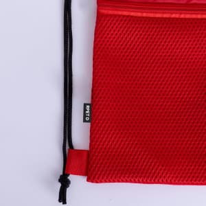 A red drawstring bag with a mesh texture and black drawstrings, featuring a small logo label.