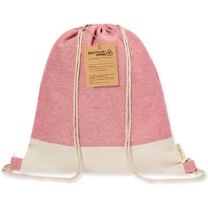 A pink and cream drawstring bag made from recycled cotton, featuring a drawstring closure and a tag.