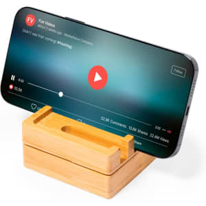 A bamboo phone stand holding a smartphone, displaying a video with a play button on the screen.
