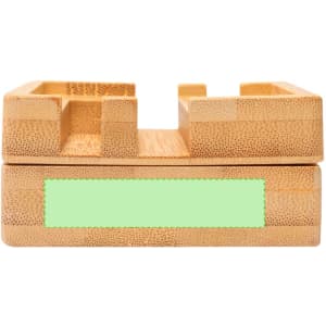A bamboo desk organiser in natural light brown with a smooth finish and a green accent area.