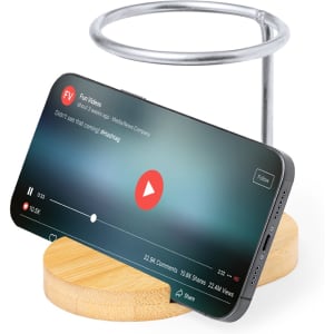 A wooden pencil holder with a metallic ring, holding a smartphone in an upright position.