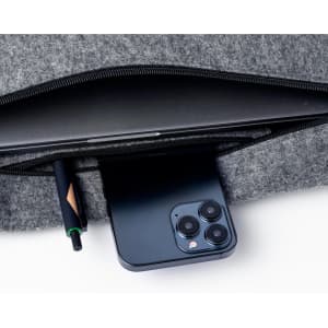 A grey laptop bag featuring a pocket with a pen and a smartphone neatly placed inside.