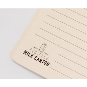 Agnila Notebook featuring lined pages and a textured beige cover, made from recycled milk cartons.