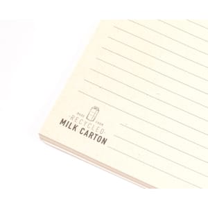 A notepad featuring lined pages, made from recycled materials, with a cream colour and a logo at the corner.