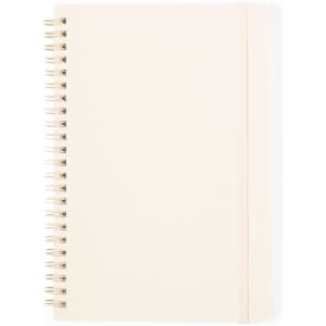 A cream-coloured notebook with a spiral binding and a hard cover.