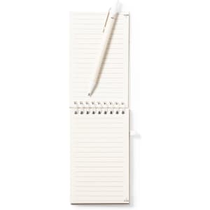 A light-coloured notebook with lined pages and a pen positioned on top, featuring a spiral binding.