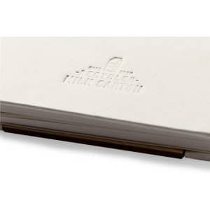 A white notebook with a textured cover, featuring an embossed logo and bound with a wooden clip.