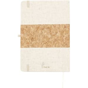 A notepad with a textured beige cover and a cork band. It features a logo and has an elastic closure.