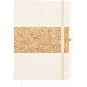 A notepad with a textured cream cover and a cork strip in the centre, featuring an elastic band.