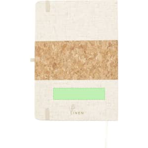 A notepad featuring a linen cover with a cork band, showcasing neutral colours and a logo at the bottom.