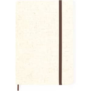 A notepad in cream with a brown elastic band, featuring a textured cover and a branding logo.