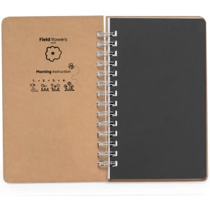 A spiral-bound notebook with a brown cover and black pages, featuring planting instructions and a simple logo.