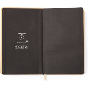 A notepad with a black cover and interior, featuring planting instructions for field flowers. It includes a logo.